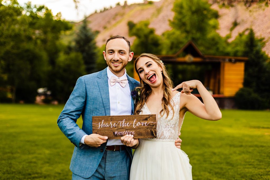 Couple poses with their hashtag sign