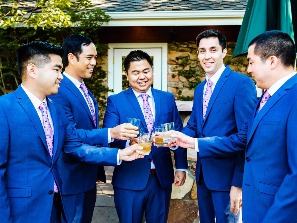 Groom and groomsmen having  drink before wedding ceremony